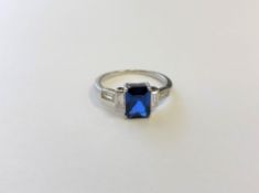 A sterling silver Art Deco style ring set with a blue stone, size N.