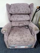 An electric reclining armchair in mauve floral fabric