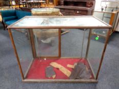 An early 20th century oak framed shop display cabinet,
