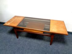 A teak G Plan coffee table with under shelf fitted with a smoked glass panel,