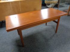 A teak extending coffee table,