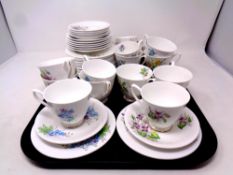 A tray containing Royal Albert flower of the month teacups and saucers