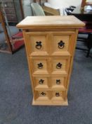 A stripped pine four drawer media chest
