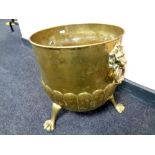 A Victorian brass coal bucket with lion mask handles on paw feet