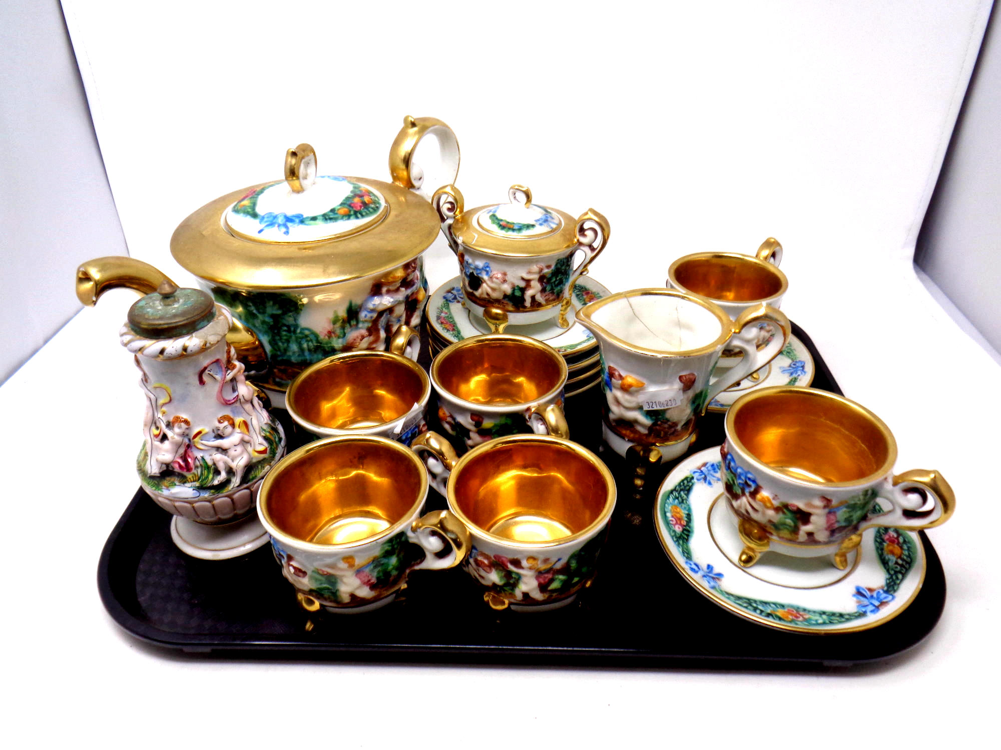 A tray containing seventeen pieces of Italian Capodimonte gilt tea china including a pair of salt