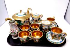 A tray containing seventeen pieces of Italian Capodimonte gilt tea china including a pair of salt