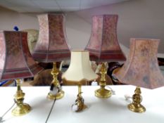 Two pairs of brass table lamps with shades together with a further brass table lamp with shade
