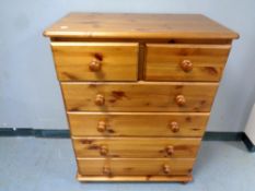 A contemporary pine five drawer chest