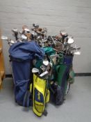 Ten golf bags containing a large quantity of assorted adult's and children's drivers,
