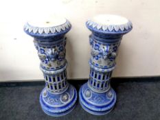 A pair of 19th century Westerwald style glazed pottery jardiniere stands decorated with lion masks