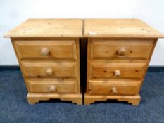 A pair of stripped pine three drawer bedside chests