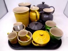 A tray containing ten pieces of ceramic Le Creuset kitchenware