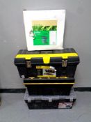 Three plastic toolboxes together with a garden trolley,