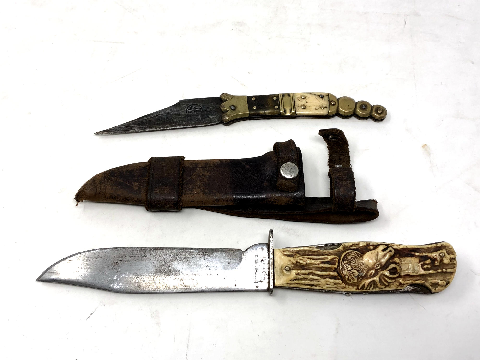 A German hunting knife in leather sheath together with a 19th century Spanish Navaja folding knife