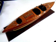 A wooden model of a vintage speedboat,
