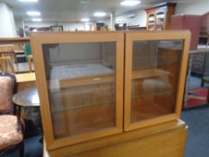 A 20th century teak double door wall cabinet,