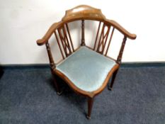 An Edwardian corner armchair