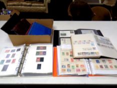 A box of eight albums and folders containing world stamps and first day covers