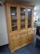 A stripped pine farmhouse kitchen cabinet, fitted cupboards and drawers beneath, width 155 cm,