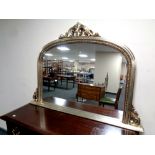 A contemporary arched overmantel mirror,