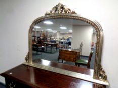 A contemporary arched overmantel mirror,