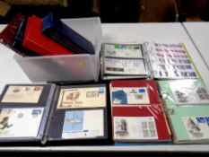 A box of eight albums containing world stamps and first day covers