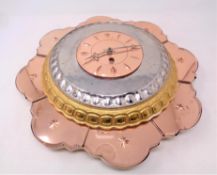 An Art Deco two tone glass wall clock in the form of a flower petal