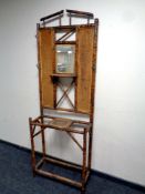An early 20th century bamboo and wicker mirrored hall stand