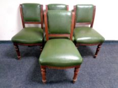 A set of four Edwardian mahogany dining chairs upholstered in green vinyl