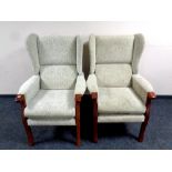A pair of wingback armchairs in beige fabric