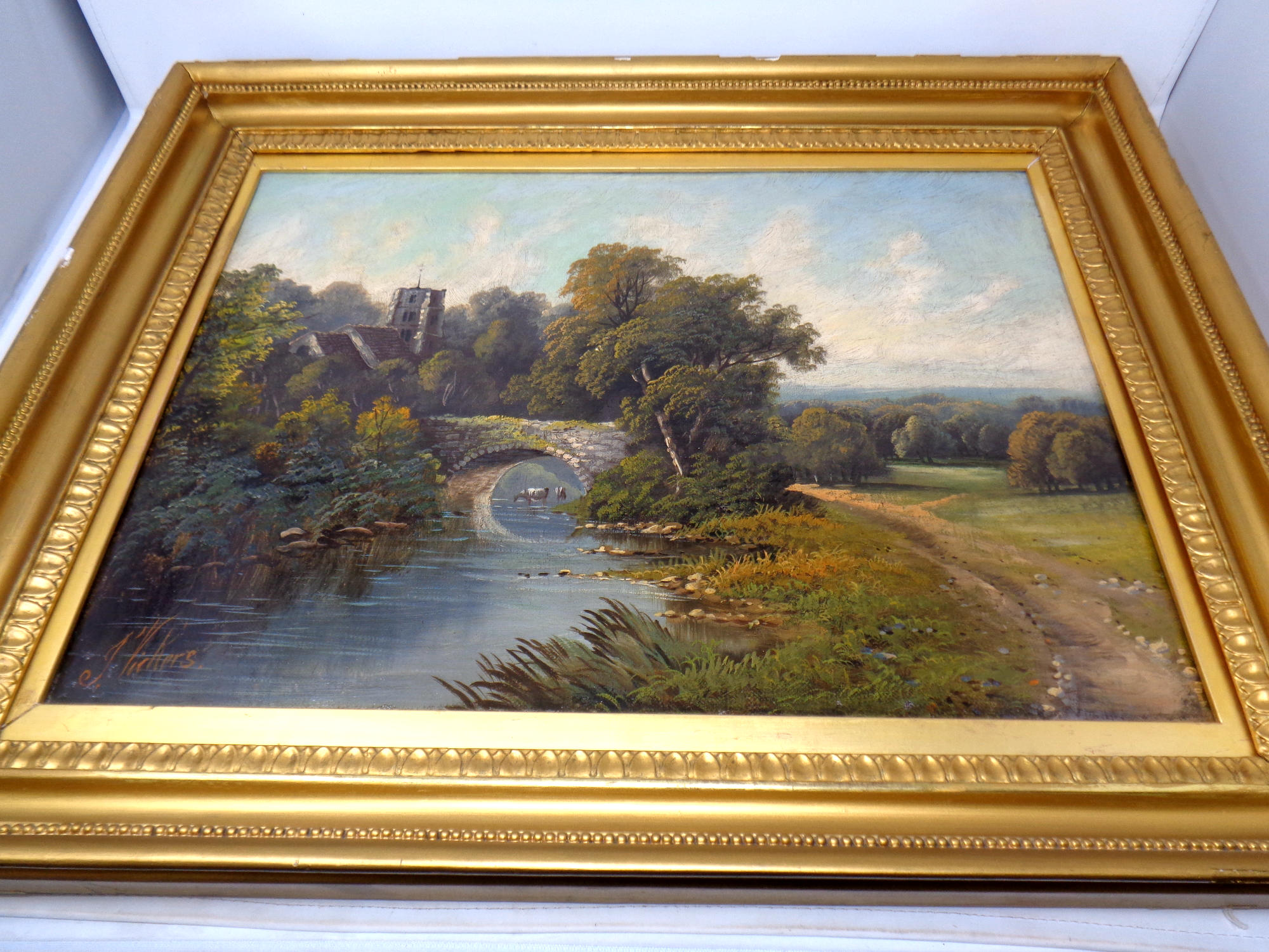 J Vickers (late 19th/ early 20th century) : A bridge over a stream with church beyond,