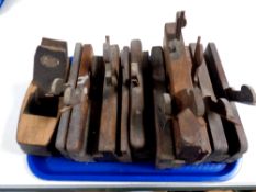 A tray containing a quantity of vintage moulding planes