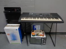 A Yamaha PSR 200 keyboard on stand together with a Hinari microwave, a Corby trouser press,