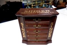 A table top jewellery chest bearing Singer advertisement