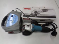 A Makita angle grinder and a ring dual volt charger