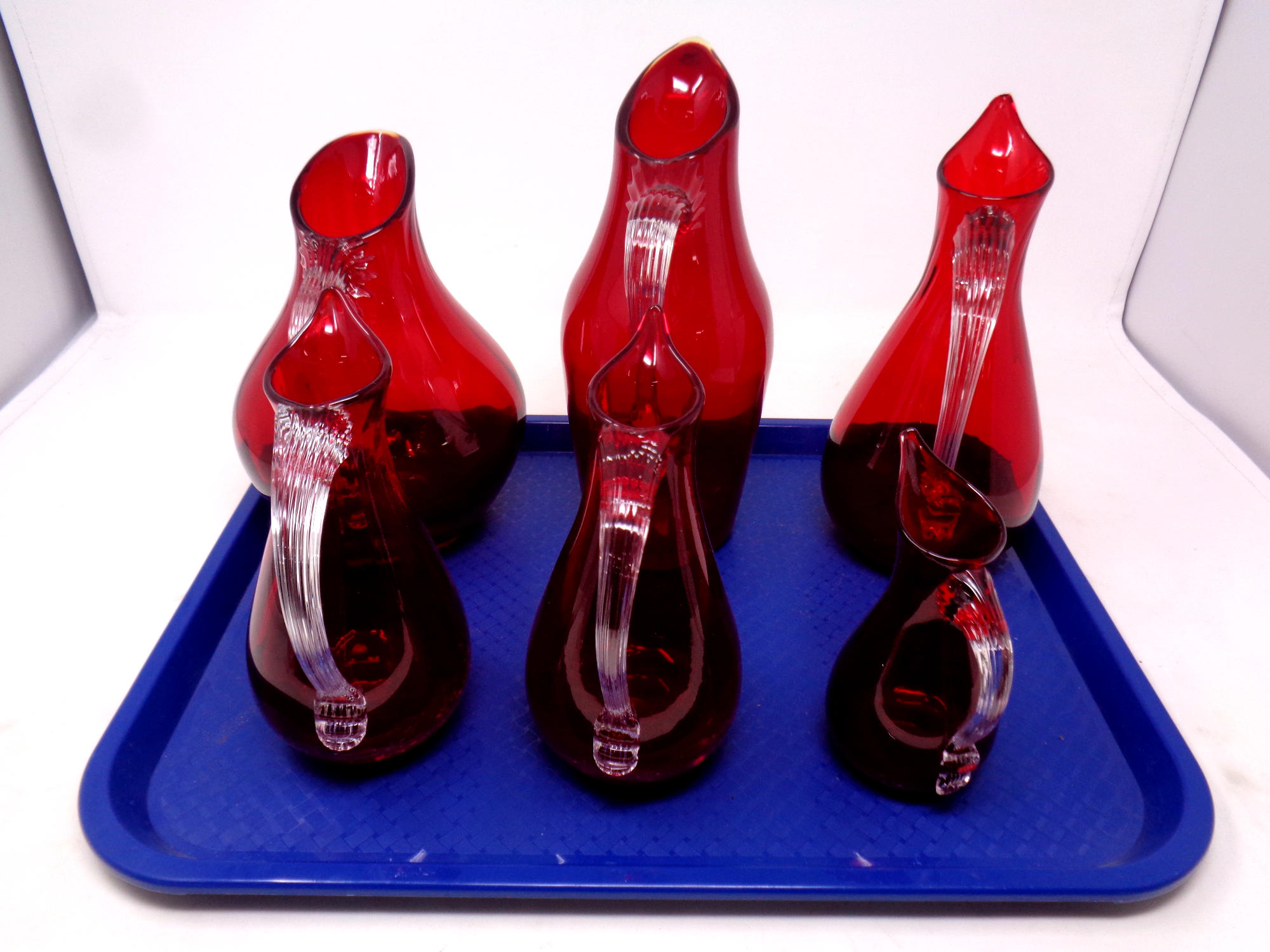 Six Whitefriars red glass jugs