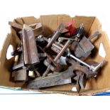 A box containing vintage woodworking tools to include hand planes, saws,