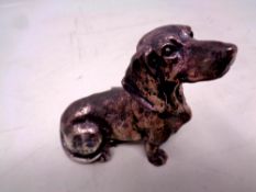 A silver filled figure of a dachshund