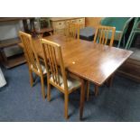 A 20th century teak G-plan dining table, length 153 cm with four Morris of Glasgow rail back chairs