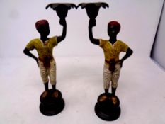 A pair of painted bronze blackamoor candlesticks,