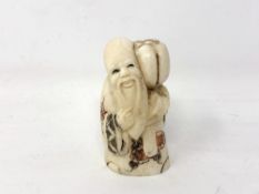 A Japanese carved bone netsuke - Village elder carrying a pumpkin on his shoulder.