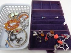 A basket containing a small quantity of costume jewellery, silver bangle, dress rings,