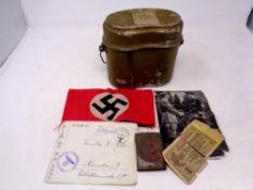 A collection of German Nazi items to include metal canteen, belt buckle, swastika arm band,