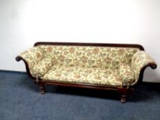 A Victorian mahogany framed scroll arm settee in floral fabric