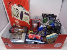 A box containing assorted plastic and die cast vehicles, vintage tin, Star Trek ships,