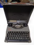 A vintage The Baby Empire typewriter in case