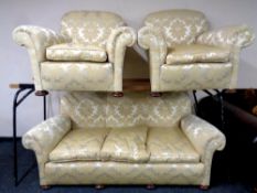 An early 20th century three piece lounge suite in gold classical fabric