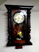 An Edwardian wall clock with brass and painted dial,