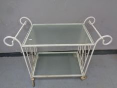 A 20th century wrought iron and glass two tier tea trolley
