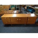 A 20th century teak G Plan triple door sideboard, fitted four drawers, on raised legs, width 199 cm